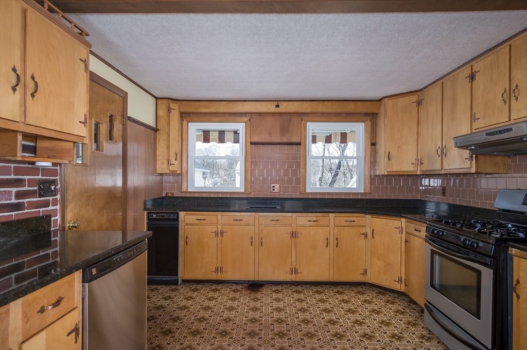 2 Worcester Street Clinton, MA 01510 - Photo 5 of 26 a kitchen with granite countertop a stove a sink and a refrigerator