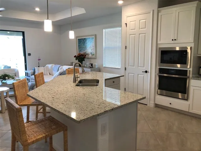 a kitchen with a table chairs and refrigerator