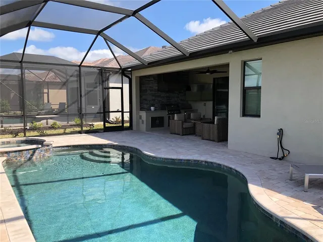 a swimming pool with outdoor seating