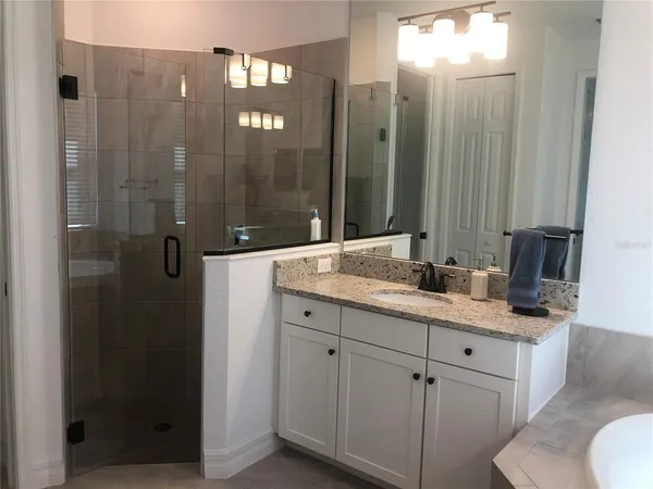 a bathroom with a double vanity sink and mirror
