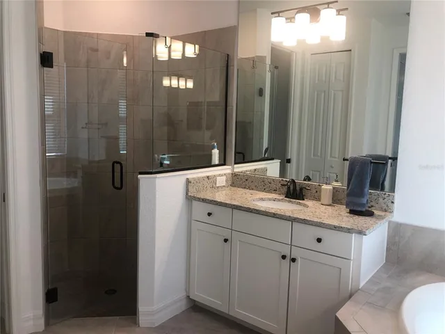 a bathroom with a double vanity sink and mirror