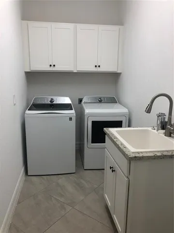 a view of cabinets with washer and dryer