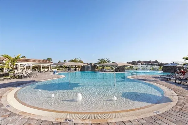 a view of a swimming pool with a yard