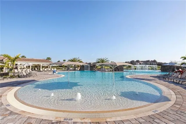 a view of a swimming pool with a yard