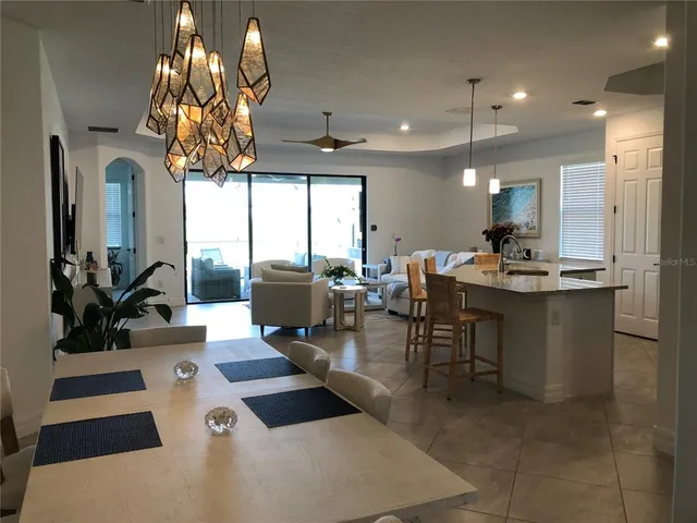 a room with dining table and chandelier