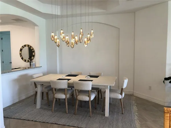 a dining room with furniture and chandelier