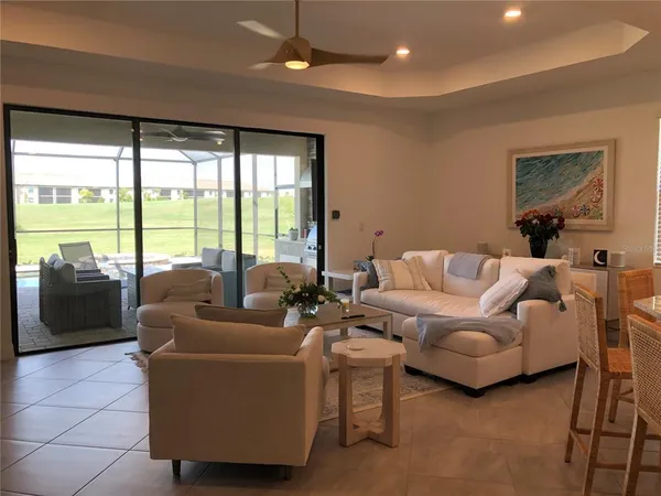 a living room with furniture and a floor to ceiling window