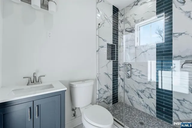 a bathroom with a sink a toilet and a mirror