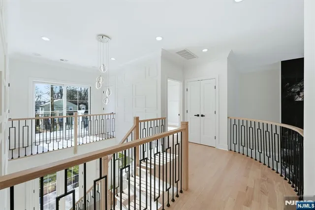 a view of a hallway with wooden floor and entryway