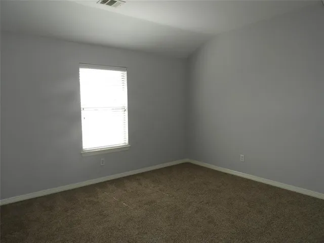 an empty room with a empty space and a window
