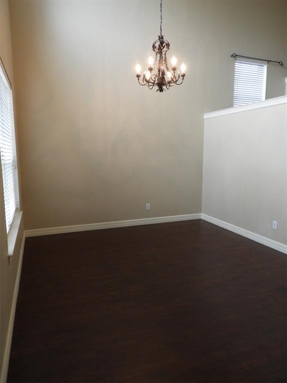 5812 Quicksilver Drive McKinney, TX 75070 - Photo 2 of 17 a view of a room with wooden floor and windows