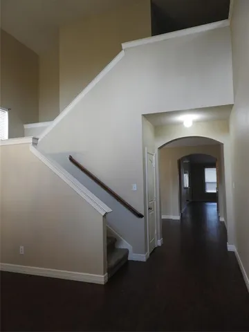 a view of a livingroom with a fireplace a chandelier and wooden floor