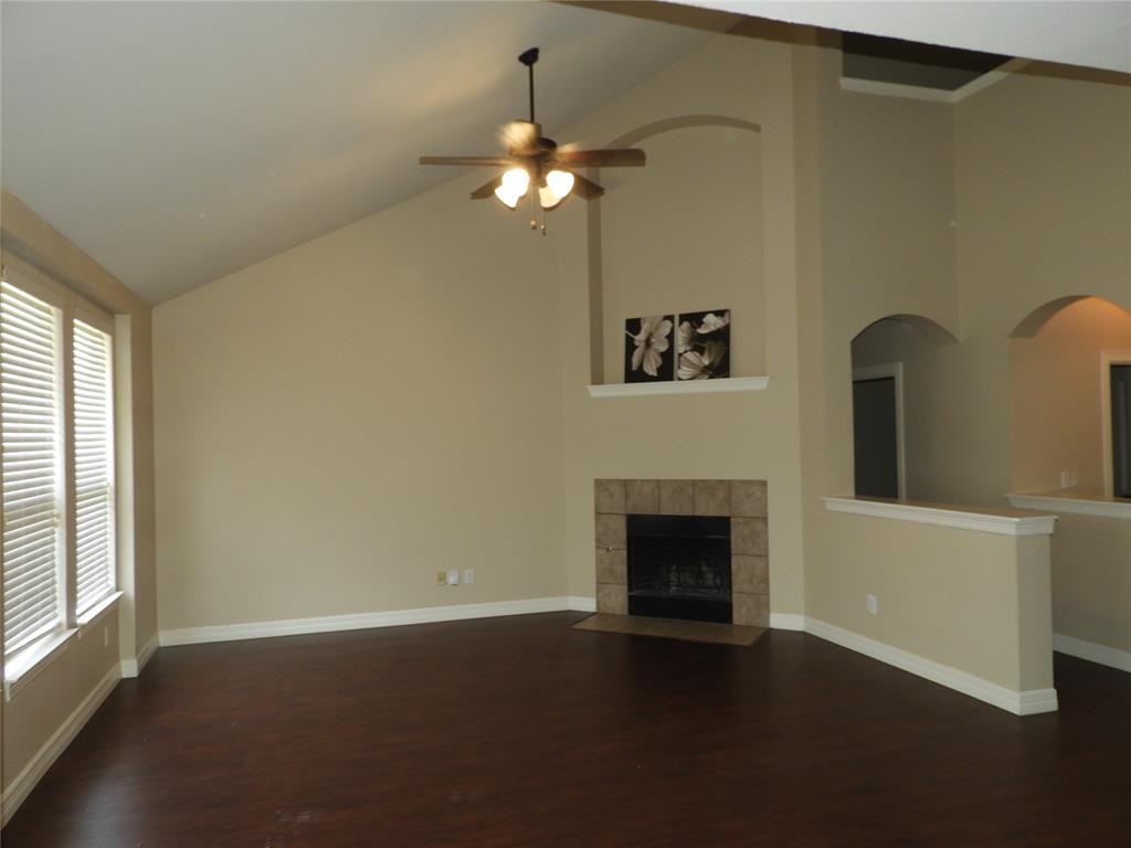 5812 Quicksilver Drive McKinney, TX 75070 - Photo 4 of 17 a view of a livingroom with a fireplace a chandelier and wooden floor