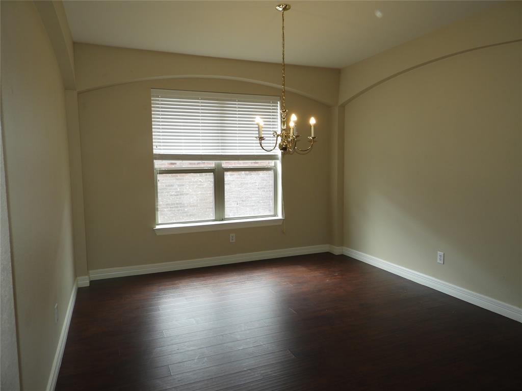 5812 Quicksilver Drive McKinney, TX 75070 - Photo 5 of 17 an empty room with wooden floor and windows