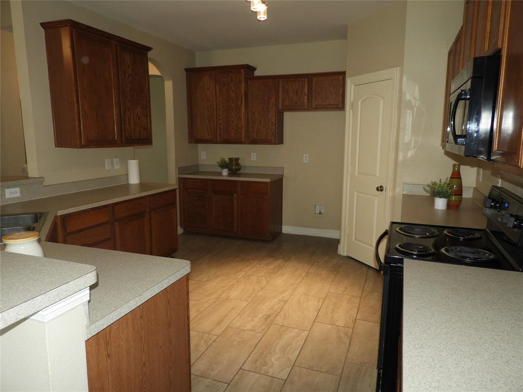 5812 Quicksilver Drive McKinney, TX 75070 - Photo 6 of 17 a kitchen with a refrigerator and a sink