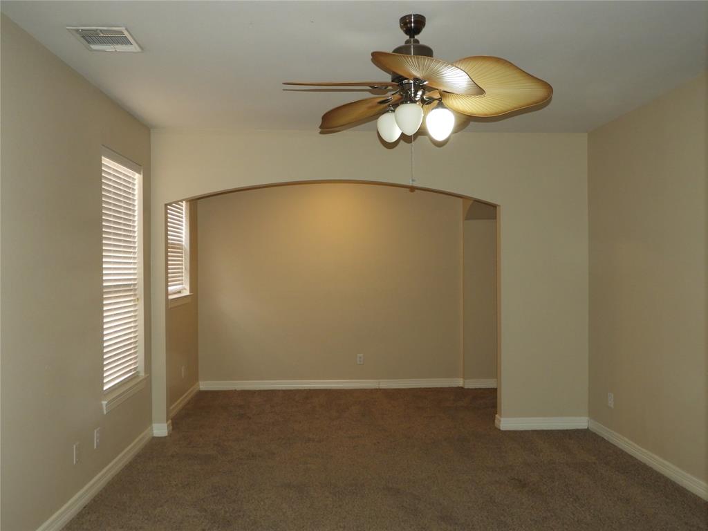 5812 Quicksilver Drive McKinney, TX 75070 - Photo 9 of 17 an empty room with a chandelier fan and wooden floor