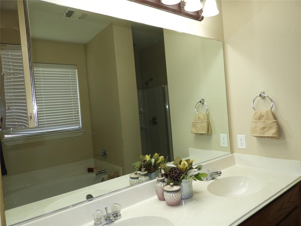 5812 Quicksilver Drive McKinney, TX 75070 - Photo 10 of 17 a bathroom with a tub sink and mirror