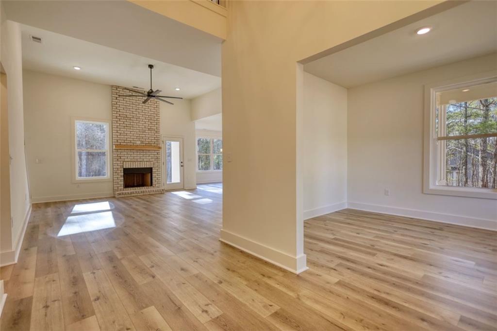 160 Loyd Road Mansfield, GA 30055 - Photo 23 of 82 an empty room with wooden floor fireplace and windows