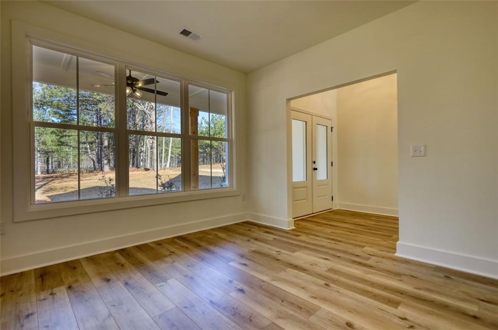160 Loyd Road Mansfield, GA 30055 - Photo 26 of 82 a view of an empty room with wooden floor and a window
