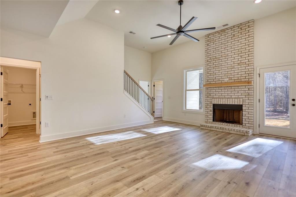 160 Loyd Road Mansfield, GA 30055 - Photo 28 of 82 an empty room with wooden floor a fireplace and a window