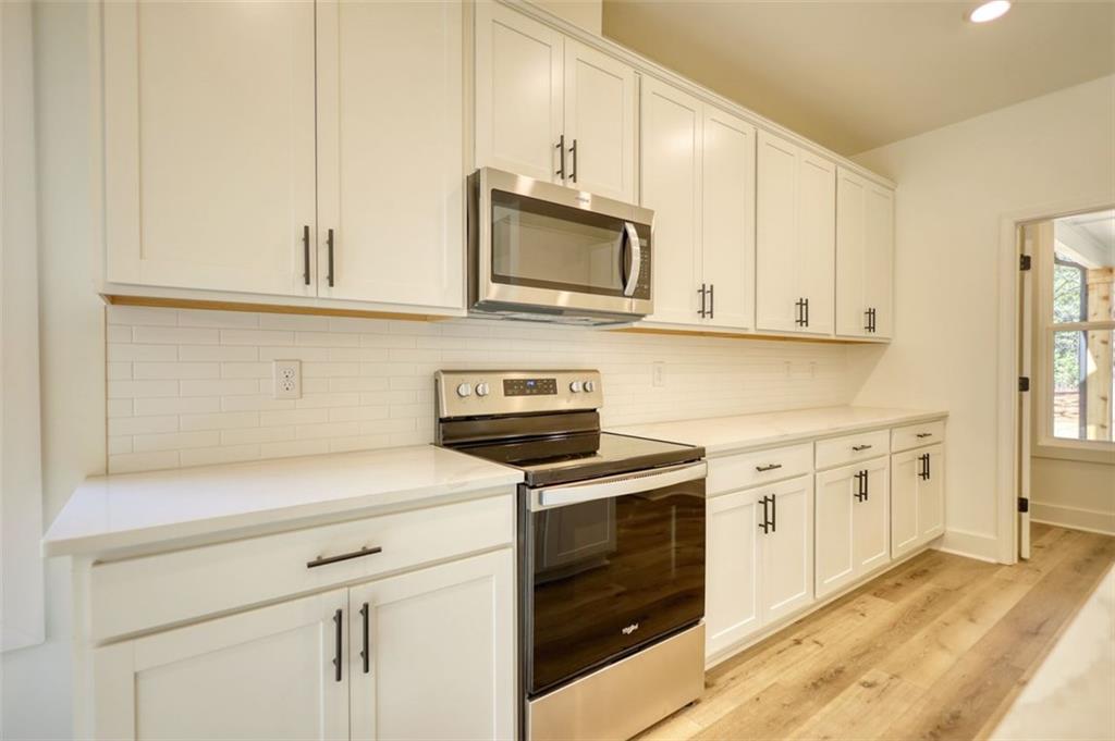 160 Loyd Road Mansfield, GA 30055 - Photo 36 of 82 a kitchen with stainless steel appliances granite countertop white cabinets and a stove a oven with white countertops