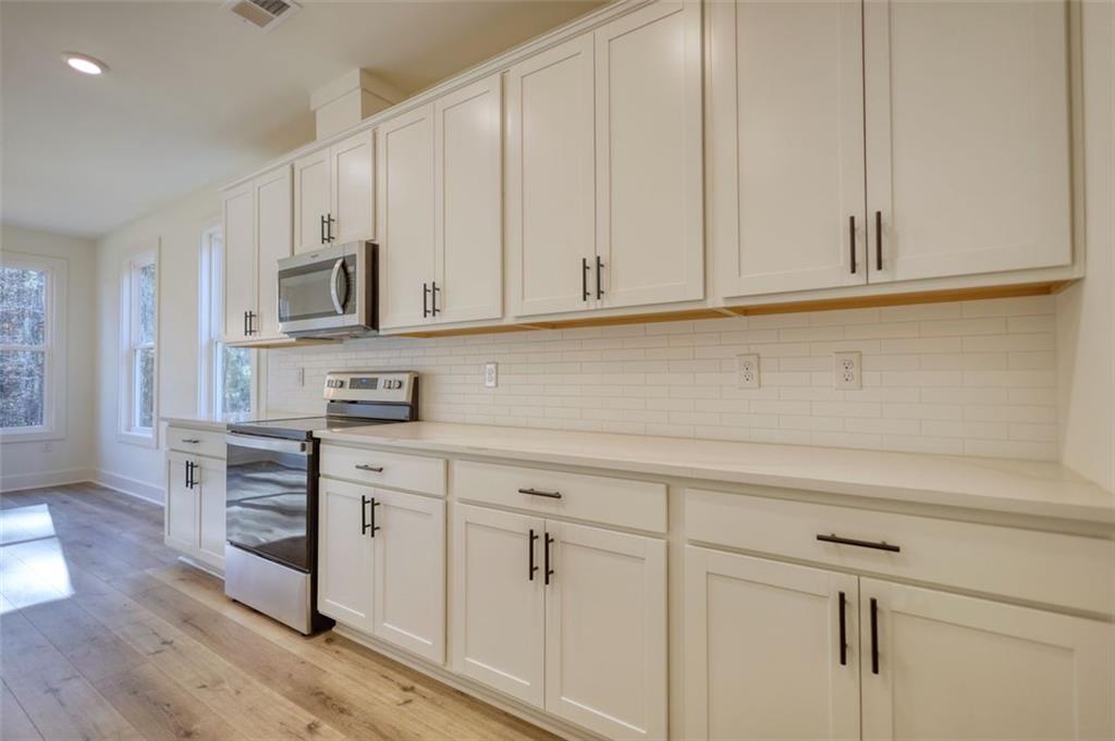 160 Loyd Road Mansfield, GA 30055 - Photo 37 of 82 a kitchen with stainless steel appliances granite countertop white cabinets and a sink