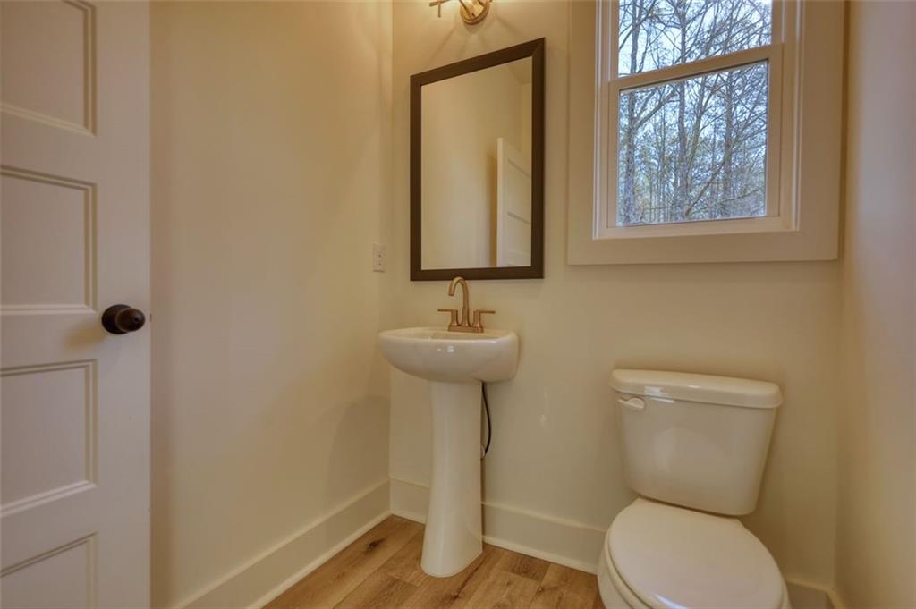 160 Loyd Road Mansfield, GA 30055 - Photo 42 of 82 a bathroom with a toilet a sink and mirror