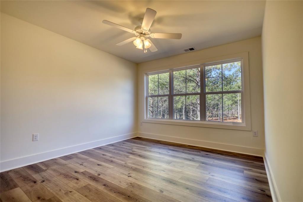 160 Loyd Road Mansfield, GA 30055 - Photo 62 of 82 an empty room with wooden floor and windows