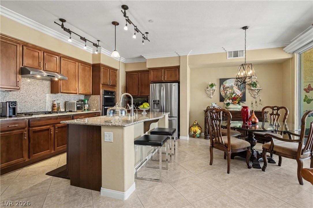 2555 Hampton Road, Unit 3308 Henderson, NV 89052 - Photo 19 of 65 Granite counters and stainless steel appliances complete this well-appointed kitchen and adjacent dining area.