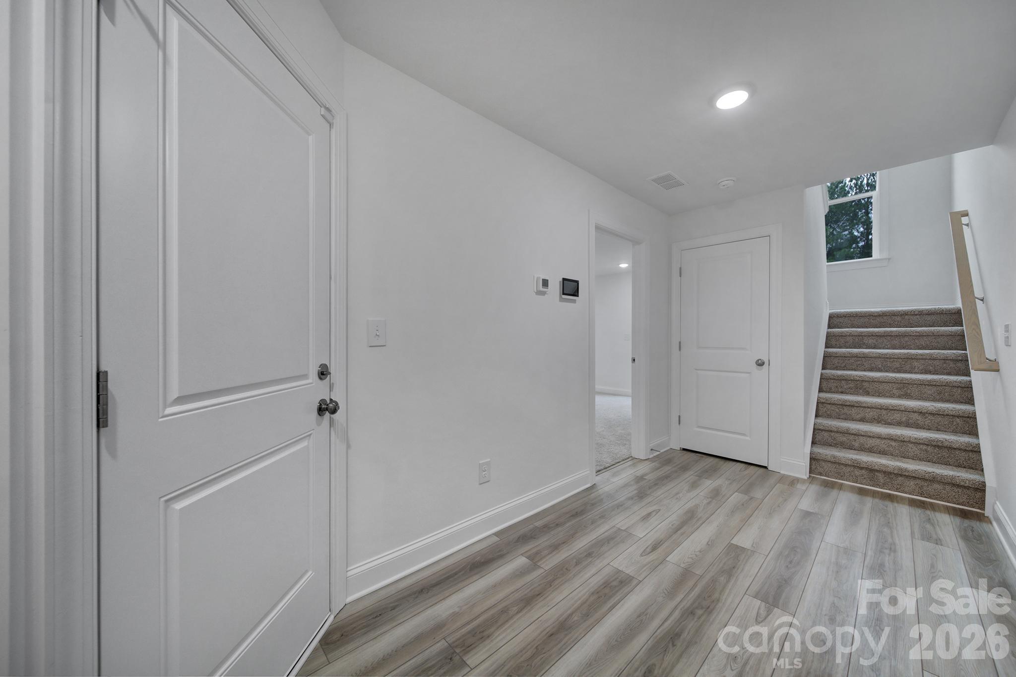 9220 Walnut Hl Road Northwest Concord, NC 28027 - Photo 2 of 14 a view of a hallway with wooden floor and entryway