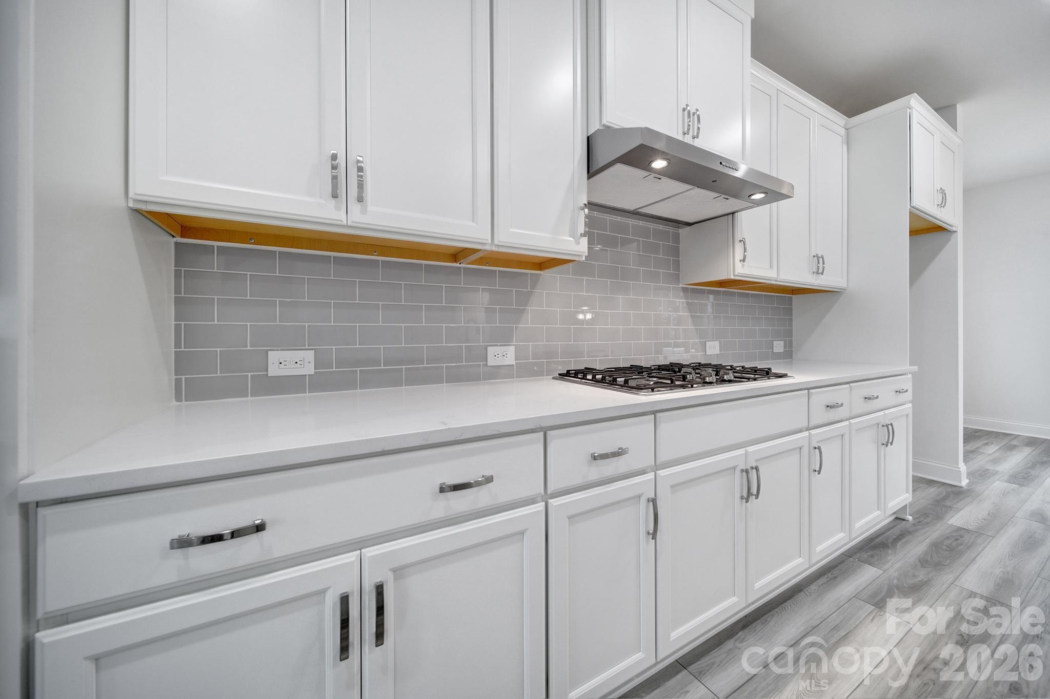 9220 Walnut Hl Road Northwest Concord, NC 28027 - Photo 7 of 14 a kitchen with white cabinets and a stove