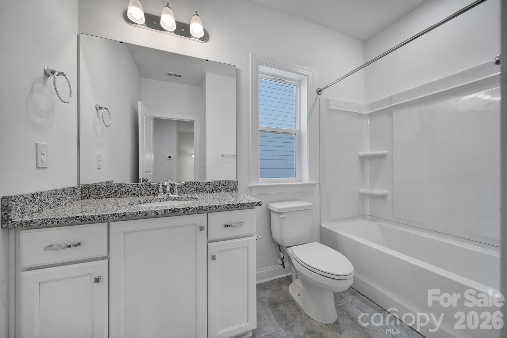 9220 Walnut Hl Road Northwest Concord, NC 28027 - Photo 9 of 14 a bathroom with a granite countertop toilet a sink and a bathtub