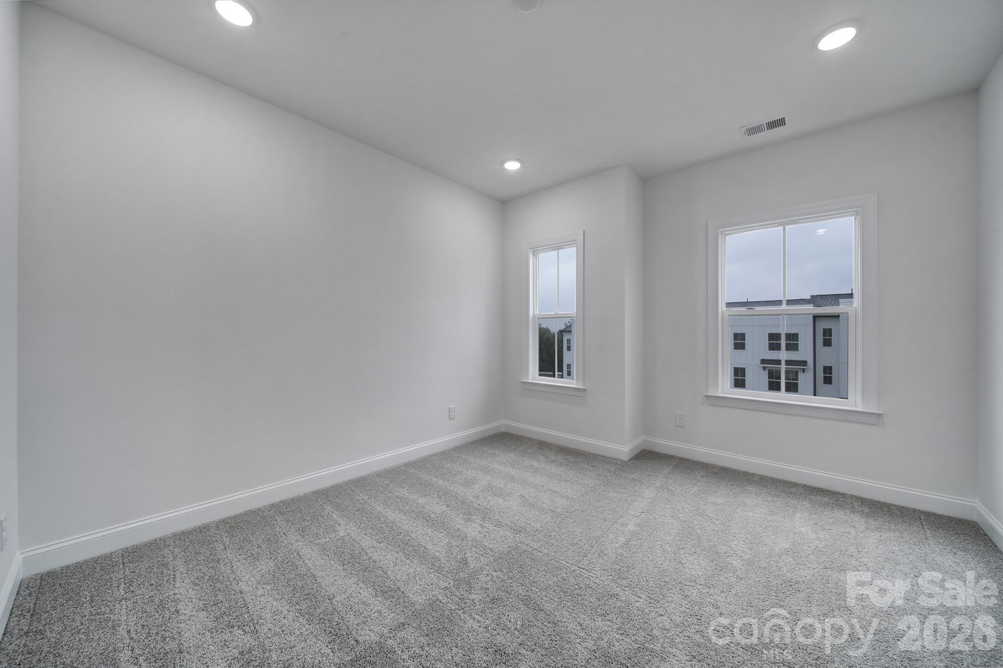 9220 Walnut Hl Road Northwest Concord, NC 28027 - Photo 10 of 14 an empty room with windows