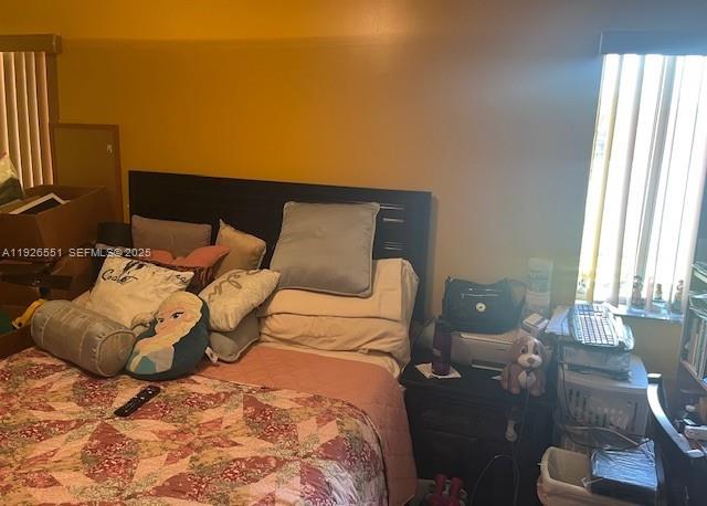 10611 Southwest 170th Terrace Miami, FL 33157 - Photo 17 of 23 a bedroom with a bed and window