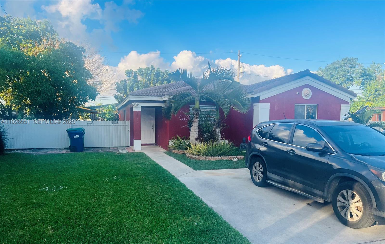10611 Southwest 170th Terrace Miami, FL 33157 - Photo 2 of 23 a front view of a house with garden