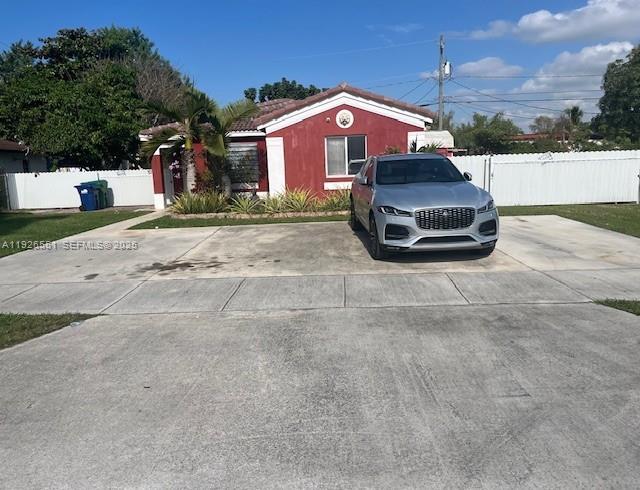 10611 Southwest 170th Terrace Miami, FL 33157 - Photo 23 of 23 a front view of a house with a yard and garage