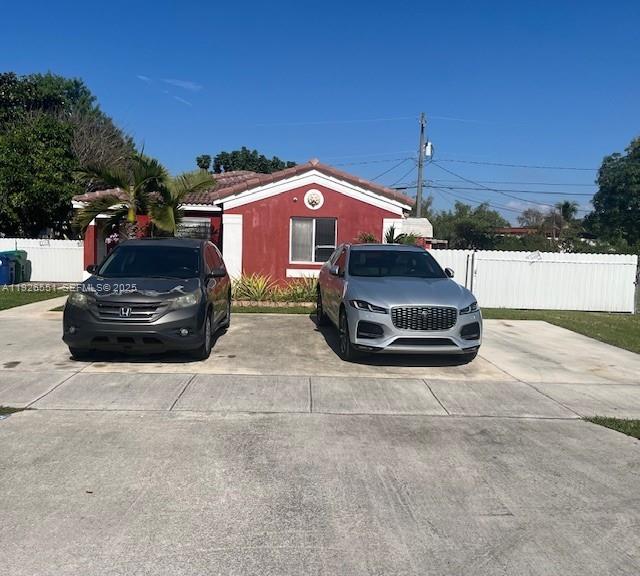 10611 Southwest 170th Terrace Miami, FL 33157 - Photo 5 of 23 a car parked in front of a yard
