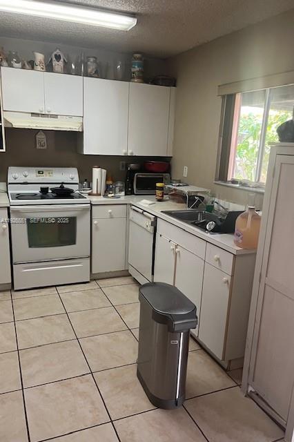 10611 Southwest 170th Terrace Miami, FL 33157 - Photo 10 of 23 a kitchen with a sink a stove and white cabinets
