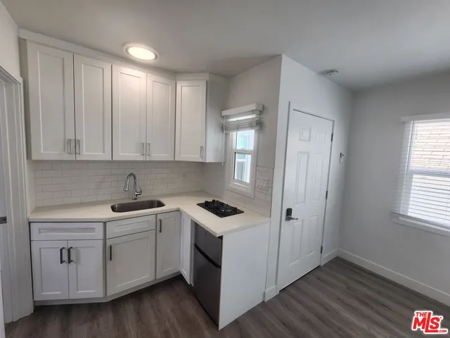 a view of cabinets a sink and dishwasher in a room