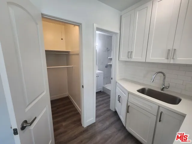 a kitchen with a sink and a refrigerator