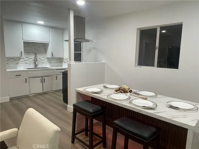 a kitchen with a sink cabinets and wooden floor