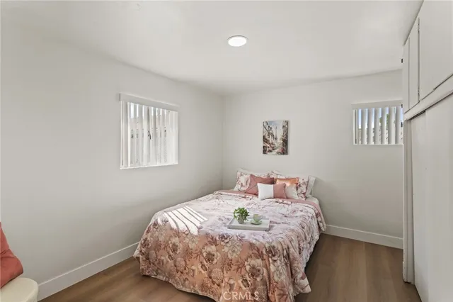 a bedroom with a bed and wooden floor