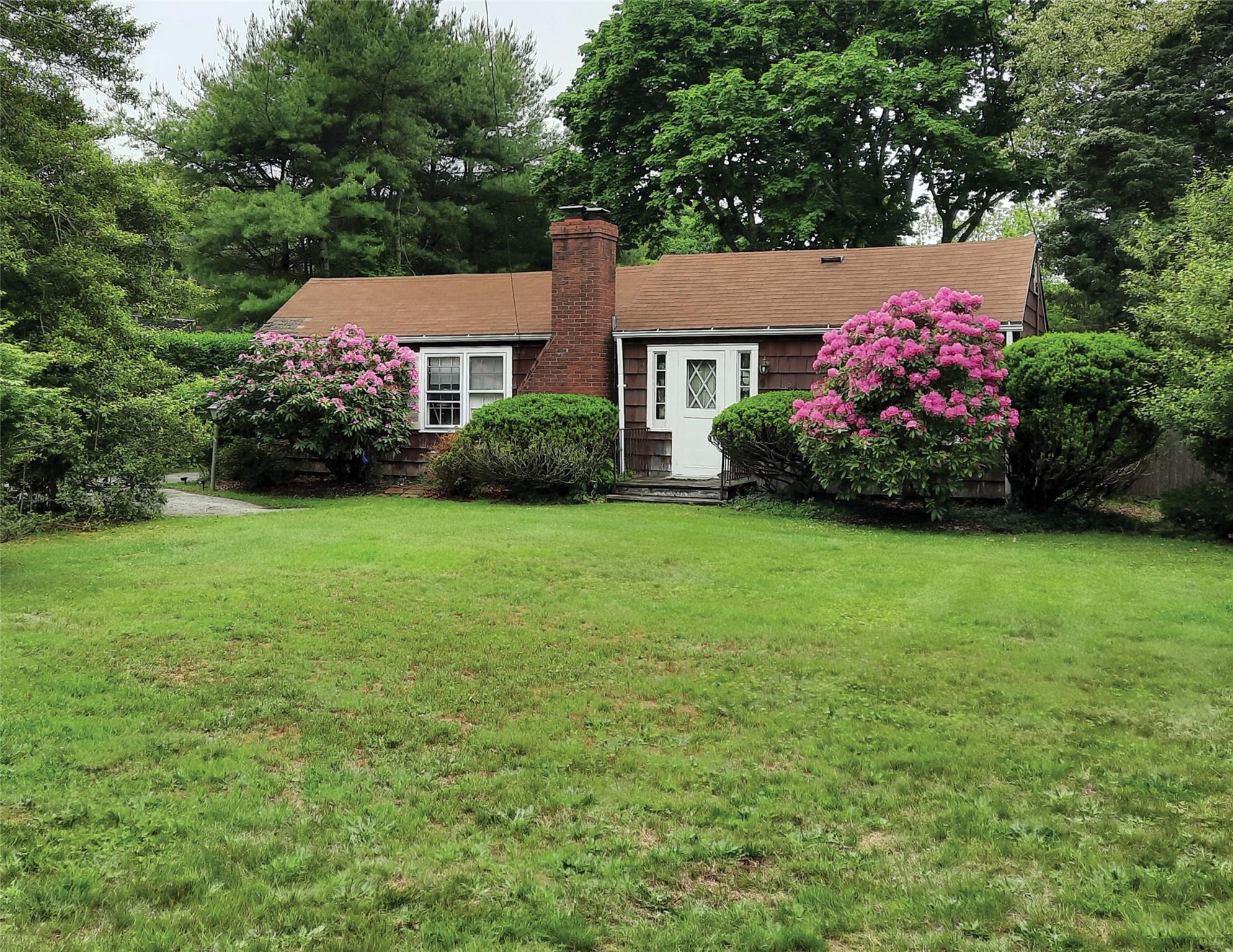 17 Club Lane Remsenburg, NY 11960 - Photo 1 of 15 a front view of a house with garden