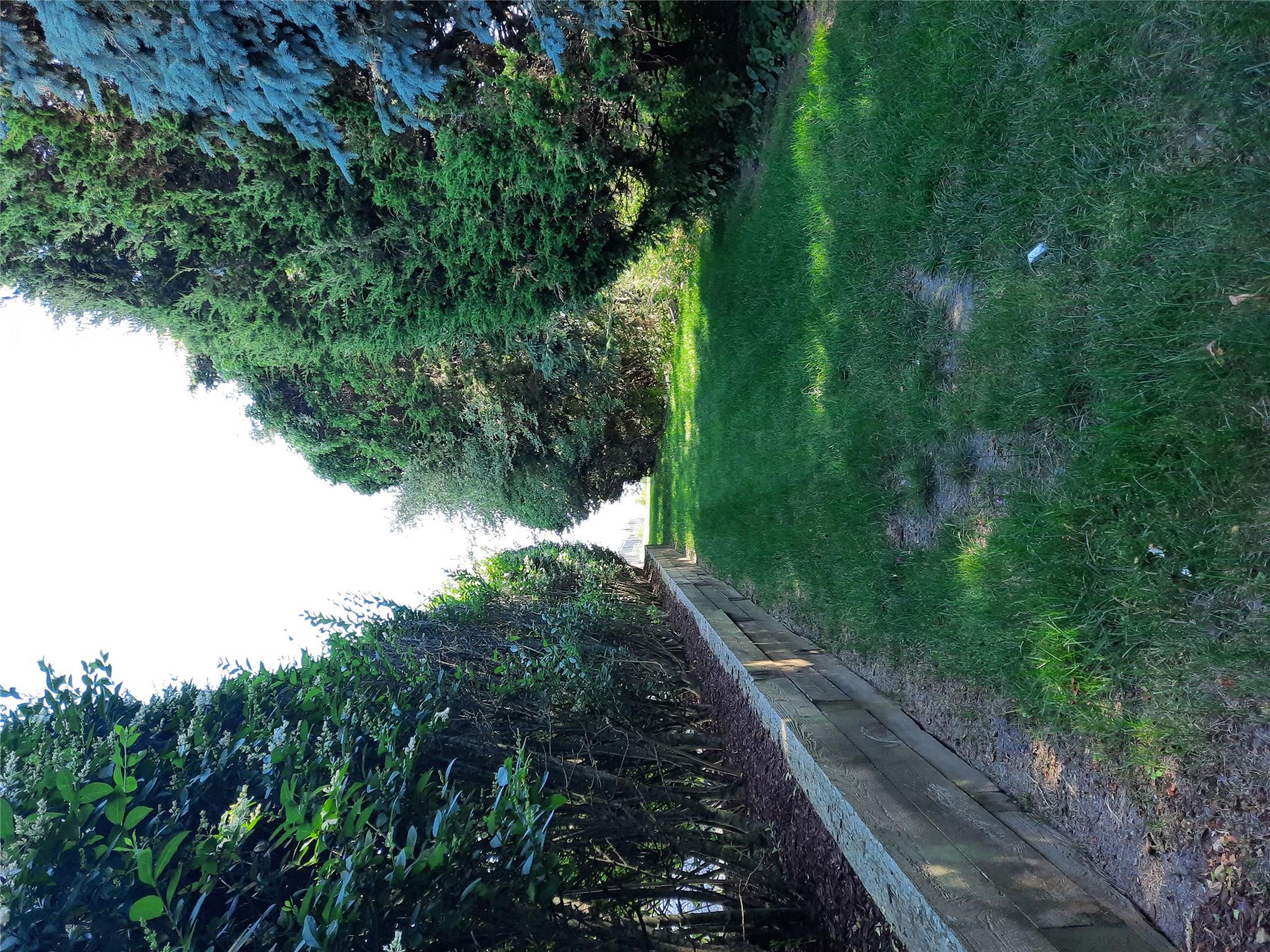 17 Club Lane Remsenburg, NY 11960 - Photo 12 of 15 a view of green field with trees in the background