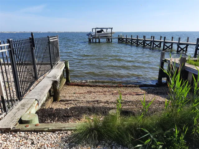 a sign board with yard and trees