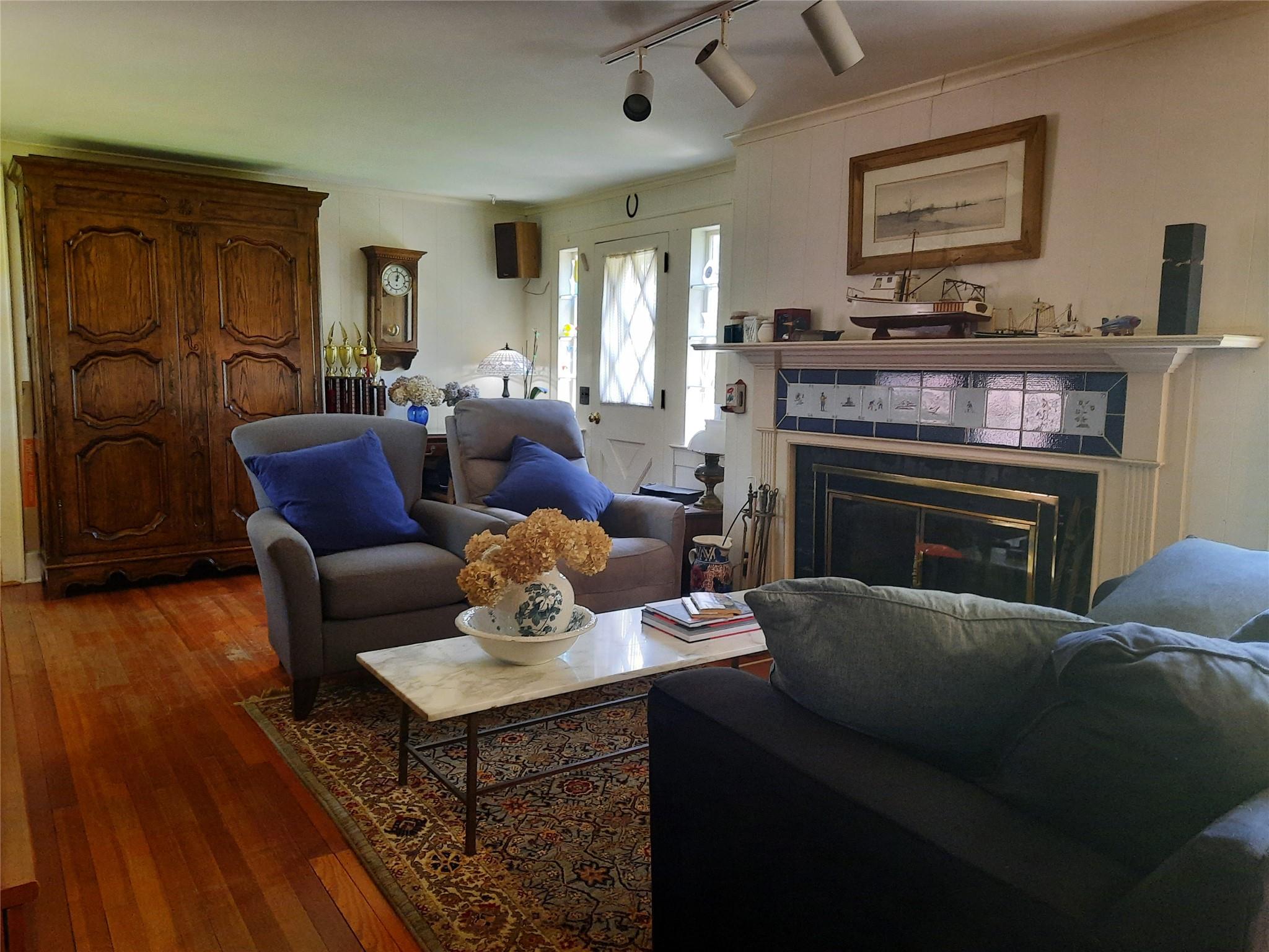 17 Club Lane Remsenburg, NY 11960 - Photo 5 of 15 a living room with furniture and a fireplace
