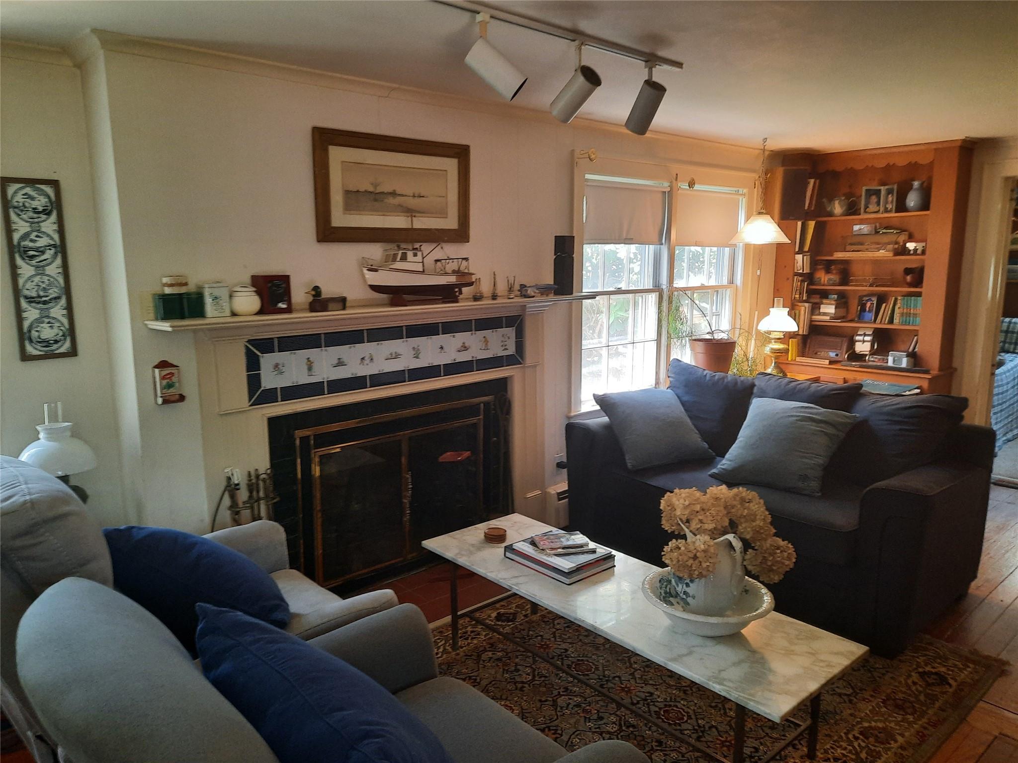 17 Club Lane Remsenburg, NY 11960 - Photo 6 of 15 a living room with furniture wooden floor and a fireplace