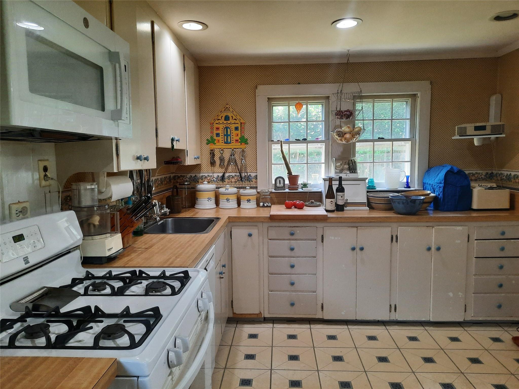 17 Club Lane Remsenburg, NY 11960 - Photo 9 of 15 a kitchen with sink a stove and cabinets