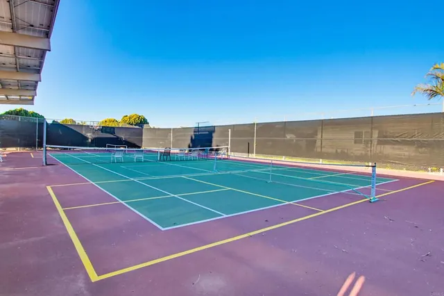 a front view of a house with a yard and potted plants