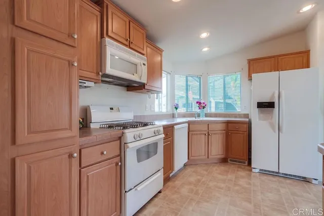 a kitchen with stainless steel appliances granite countertop a sink and a stove top oven